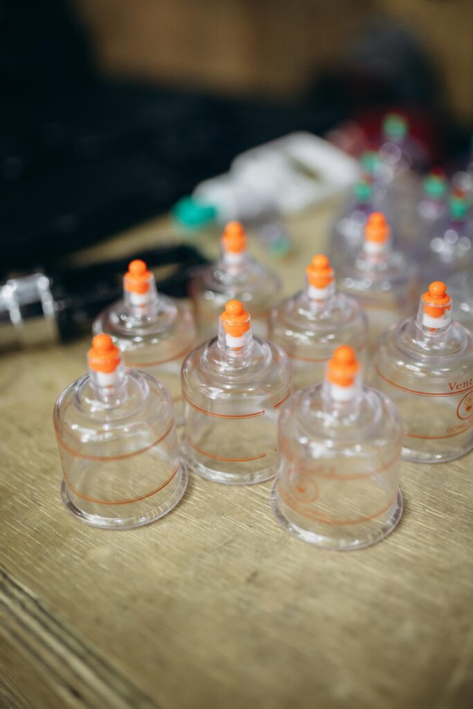 A close-up view of cupping therapy equipment on a wooden table, used for holistic treatment and wellness.